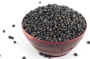 Urad dal, black gram, Vigna mungo in wooden bowl on white background photo