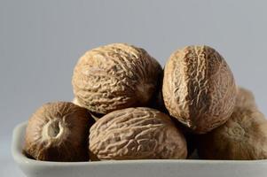 Close up of Nutmeg in a white plate photo