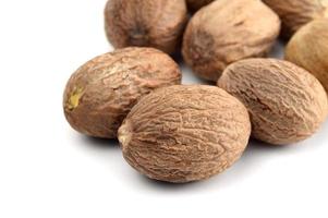 Nutmeg isolated on white background. Close up. photo