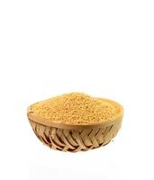 yellow mustard seeds in wooden basket isolated on white background photo