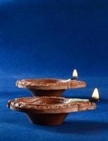 Clay diya lamps lit during diwali celebration. Greetings Card Design Indian Hindu Light Festival called Diwali photo