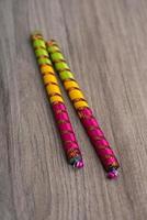 Dandiya sticks on a wooden background. Raas Garba or Dandiya Raas is the traditional folk dance photo