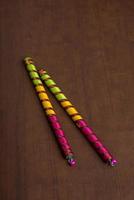 Dandiya sticks on a brown background. Raas Garba or Dandiya Raas is the traditional folk dance photo