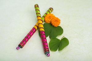 festival indio dussehra, mostrando hojas doradas de bauhinia racemosa y flores de caléndula con palitos de dandiya. foto