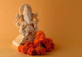 Hindu God Ganesha. Ganesha Idol on yellow background photo