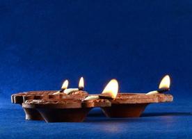 Clay diya lamps lit during diwali celebration. Greetings Card Design Indian Hindu Light Festival called Diwali photo