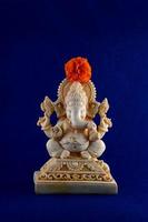 Hindu God Ganesha. Ganesha Idol on blue background photo