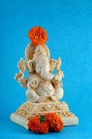 Hindu God Ganesha. Ganesha Idol on blue background photo