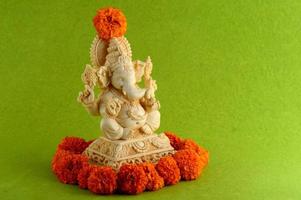 Hindu God Ganesha. Ganesha Idol on green background photo