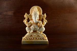 Hindu God Ganesha. Ganesha Idol on brown background photo