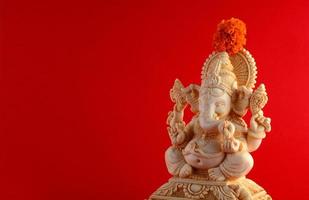 Hindu God Ganesha. Ganesha Idol on red background photo
