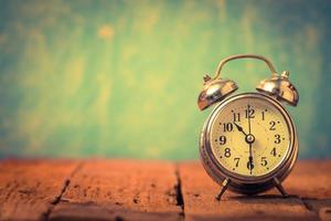 Alarm clock on vintage background photo