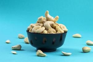 Cashew nuts in a bowl on blue background photo