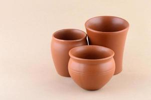 Close-up of Clay pots on cream color background photo
