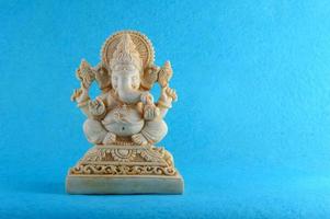 Hindu God Ganesha. Ganesha Idol on blue background photo