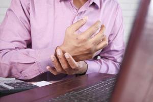 businessman suffering pain in hand close up photo