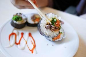 tuna Sushi on plate with chopstick on table photo