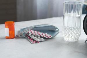 Close up of pills of blister pack in a small bag on table at home photo