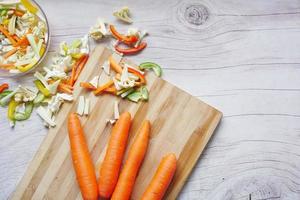 fresh carrots on chopping board on table photo