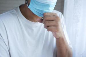 young sick man coughing and sneezes photo
