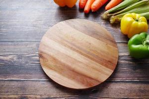 Healthy food selection with fresh vegetables on chopping board on table photo