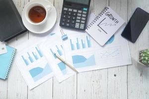 financial graph, calculator and notepad on table photo