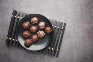 dark chocolate on a plate on black background photo