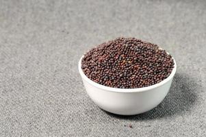 Brown Mustard Seeds in bowl on sackcloth photo