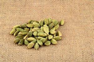 Green Cardamom pods on sack cloth photo