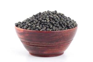 Urad dal, black gram, Vigna mungo in wooden bowl on white background photo