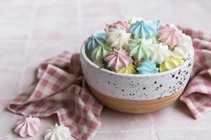 Small colorful meringues in the  ceramic bowl photo