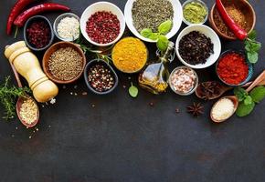 Assortment of spices on black photo