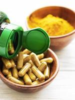 Turmeric powder and capsules photo