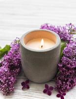 Candle and lilac flowers photo