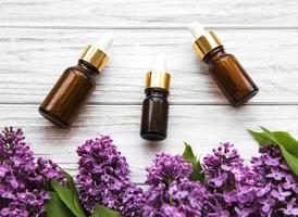 Essential oil and lilac flowers photo