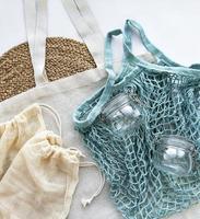 Mesh bag, cotton bags and glass jars photo