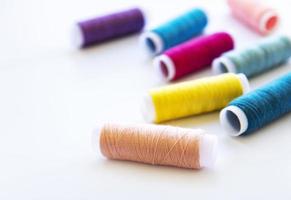 Spools of thread on a white photo