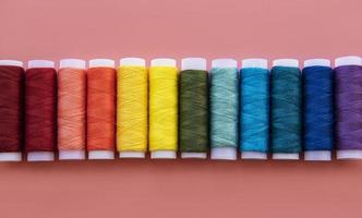 Spools of thread on the colors of the rainbow photo