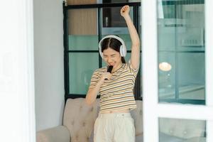 Beautiful Asian woman singing in the living room photo