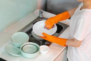 The Asian woman is washing the dishes photo