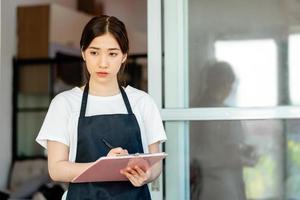 The Asian waitress is checking the hotel room after guests check out photo