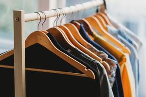 Clothes are hung on shelves at the store photo