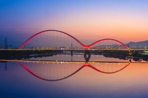 Night scene of New Taipei city by river in Taiwan photo