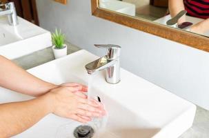 Close up woman cleaning her hands after using  toilet to prevent infection or contamination from dirty things photo