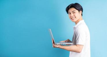 Asian man is typing on a blue background photo
