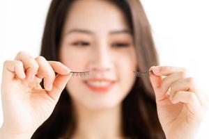 Asian woman sitting makeup in front of mirror photo