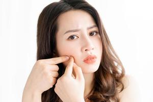 Asian woman sitting makeup in front of mirror photo