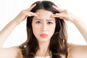 Asian woman sitting makeup in front of mirror photo