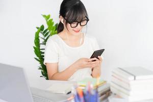 Young Asian businesswoman watching live stream at home after working online photo