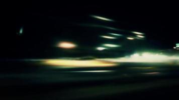Night lights streak as we travel down a city street - Loop video
